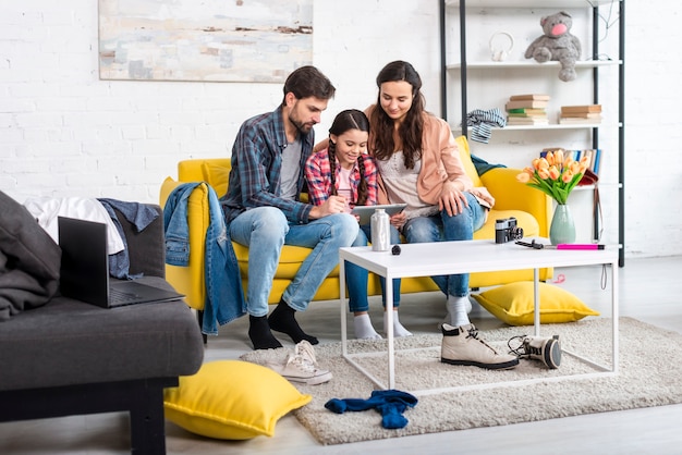 Long shot of happy family and untidy home