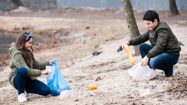 Long shot of kids cleaning the ground