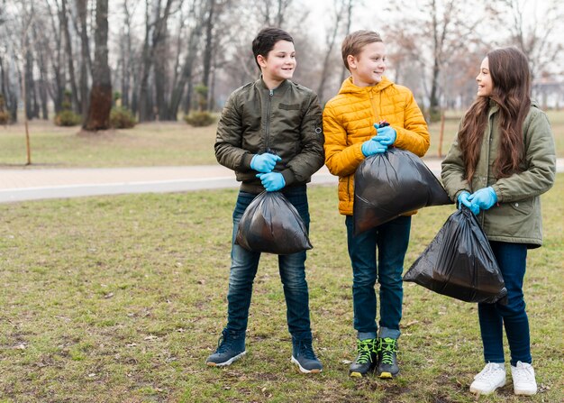 Long shot of kids holding plastic bags