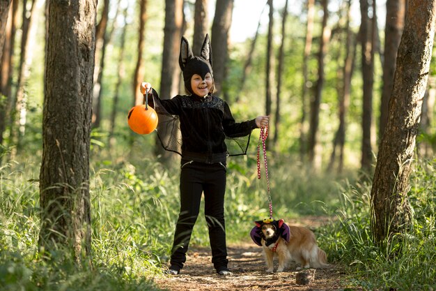 Long shot of little boy in bat costume