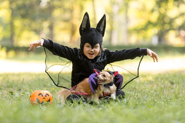 Long shot of little boy in bat costume