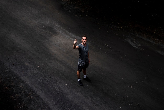 Long shot of man giving thumbs up