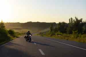 Free photo long shot man riding a motorbike