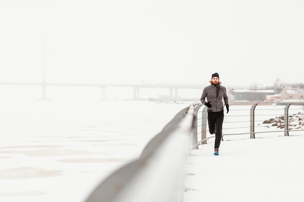 Long shot man running outdoors