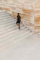 Free photo long shot man running on stairs