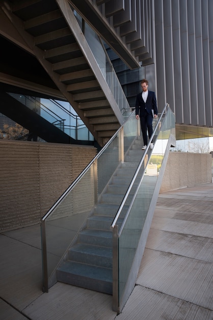 Free photo long shot man walking down stairs