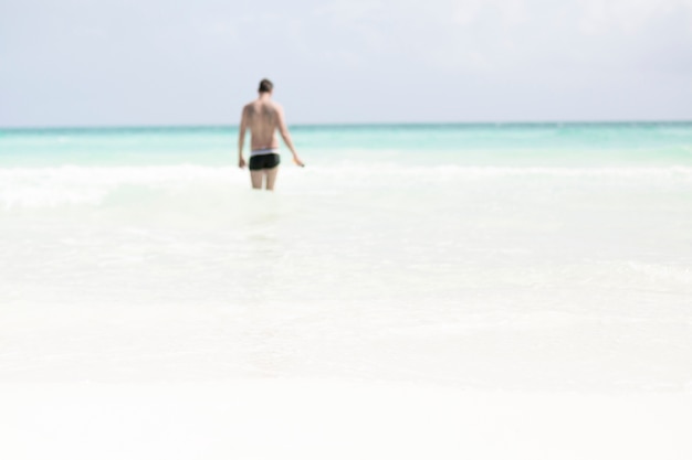 Free photo long shot of man walking in the sea