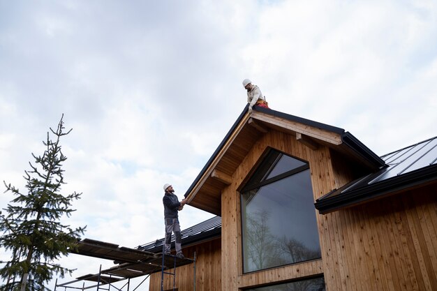 Long shot men working on roof together