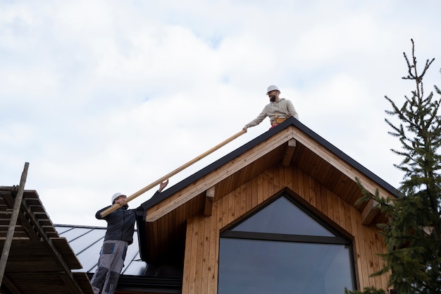 Long shot men working on roof