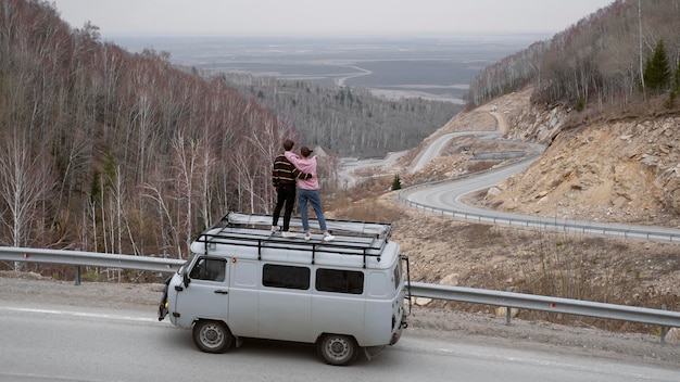 Long shot people standing on van