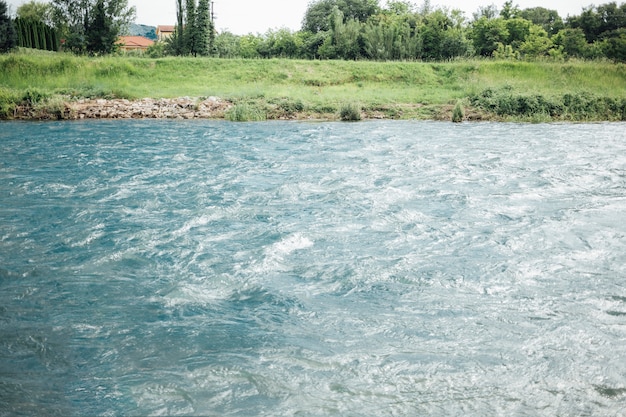 Long shot of river in farmland