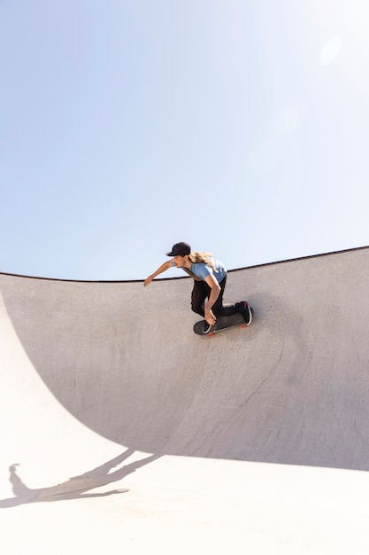 Long shot skateboarder outdoors