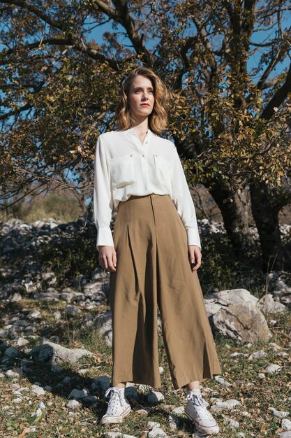 Long shot standing woman with casual outfit