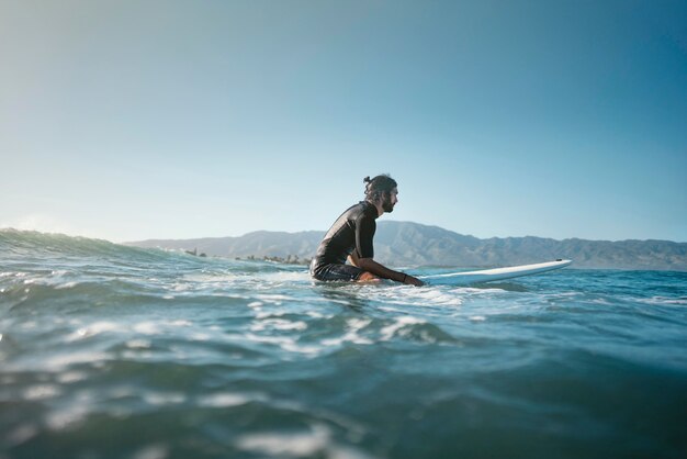 Long shot of surfer in the water