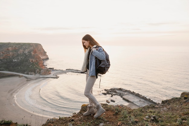 Free photo long shot of woman enjoying the peace around her