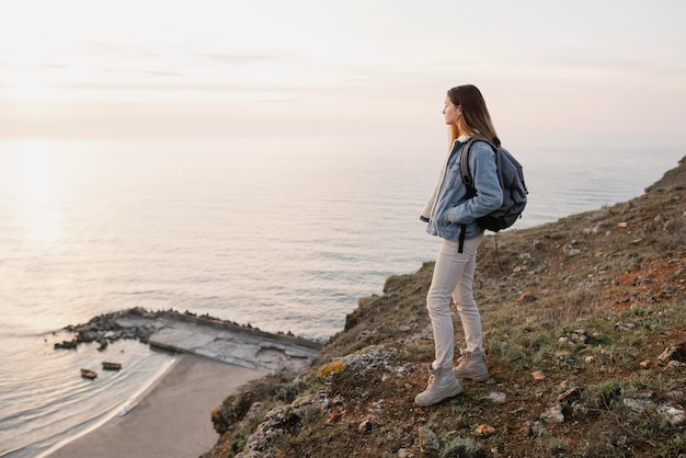 Free photo long shot of woman enjoying the peace around her