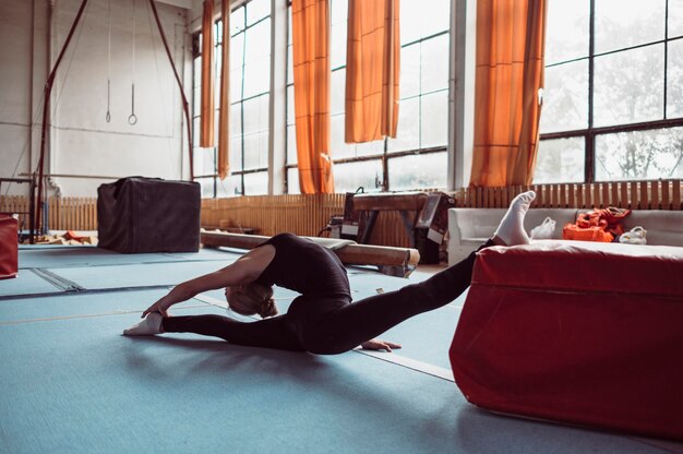 Long shot  woman exercising for gymnastics olympics