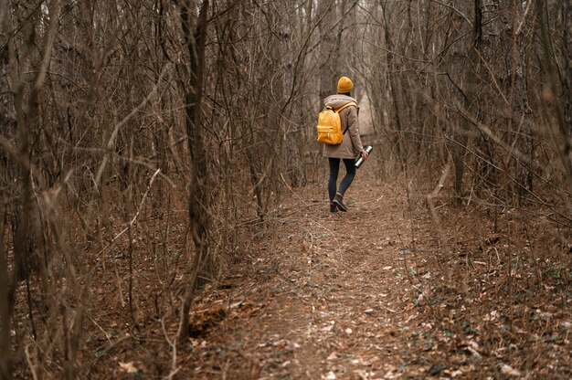 Long shot woman hiking with flask