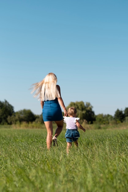 Long shot of a woman and a little girl walking