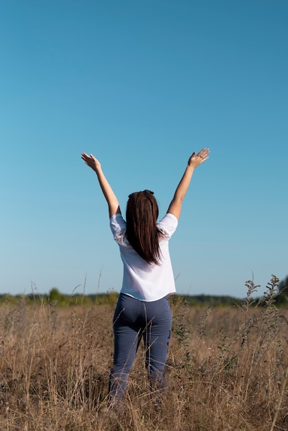 Long shot of a woman looking at the sky