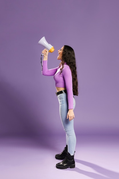 Long shot of woman shouting in megaphone