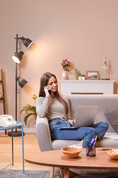 Woman Sitting on Couch and Working: Long Shot