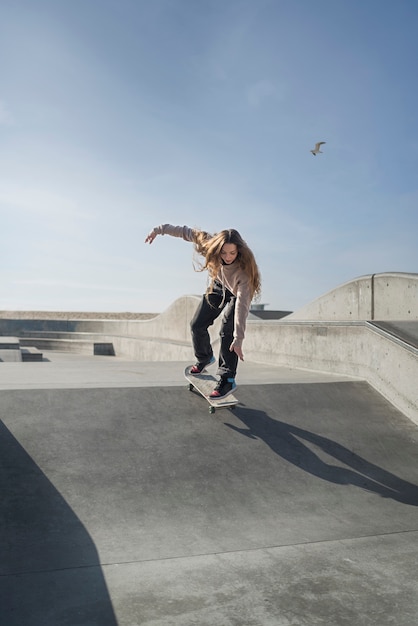 Free photo long shot woman on skateboard