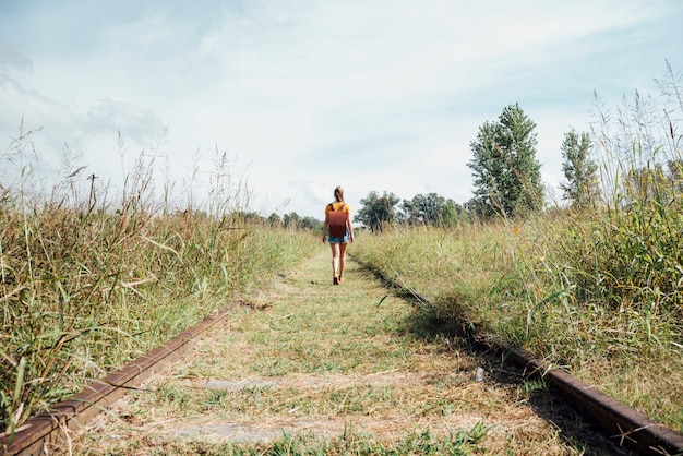 Long shot of woman walking on railway