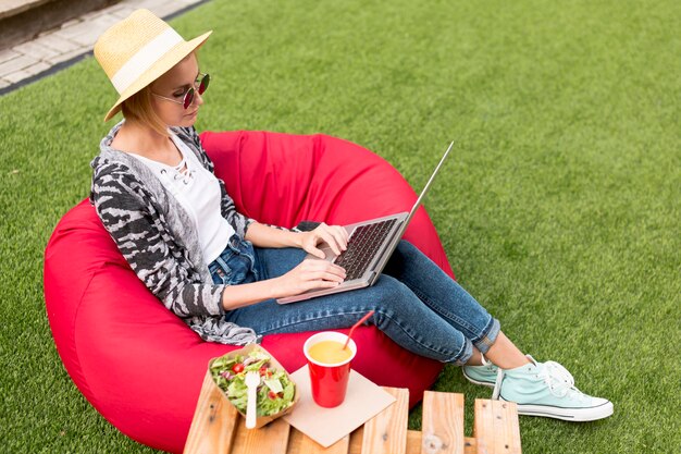 Long shot of woman working on her laptop