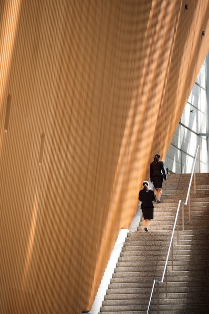 Long shot women climbing up stairs