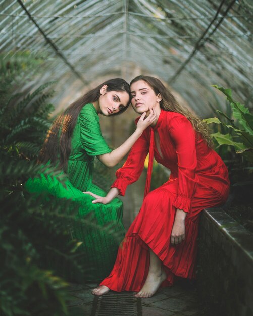 Long shot of women sitting in a green house