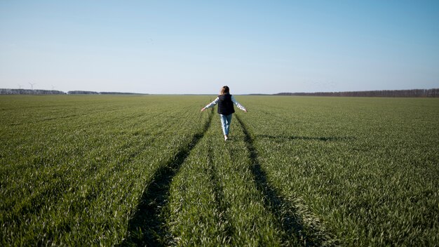 Long shot of young girl in the field