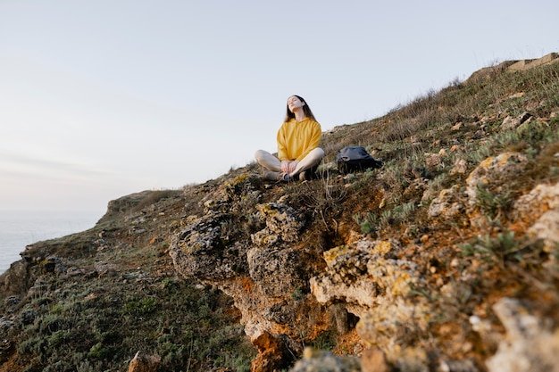 Long shot of young woman enjoying the nature around her