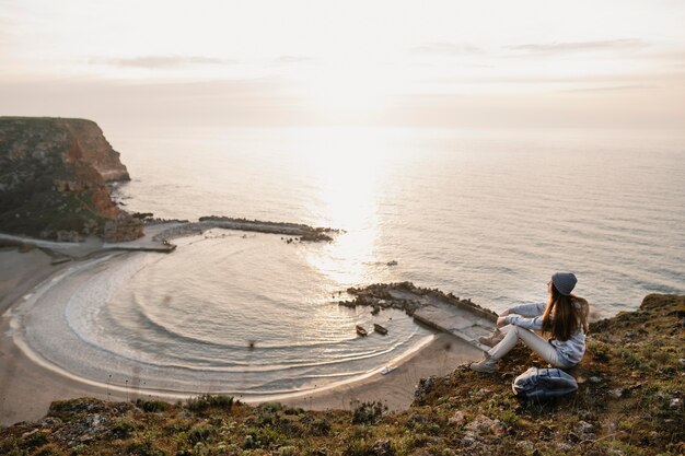 Long shot of young woman enjoying the peace around her