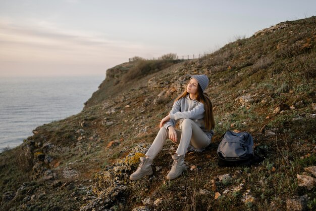 Long shot of young woman enjoying the peace around her