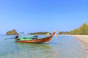 Long tail boat waiting for tourists at noppharat thara beach in andaman sea krabi thailand