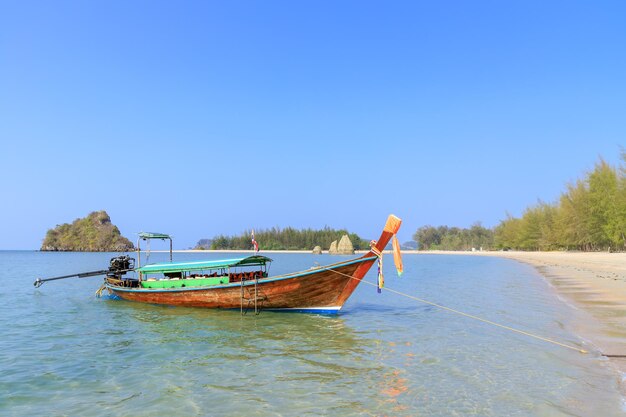 Long tail boat waiting for tourists at Noppharat Thara beach in Andaman sea Krabi Thailand