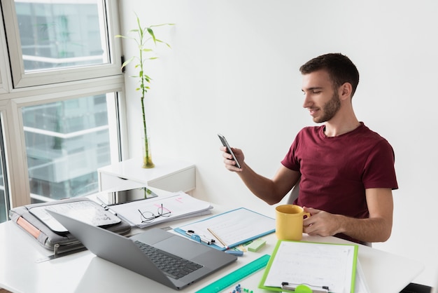 Free photo long view of man sitting at the office desk