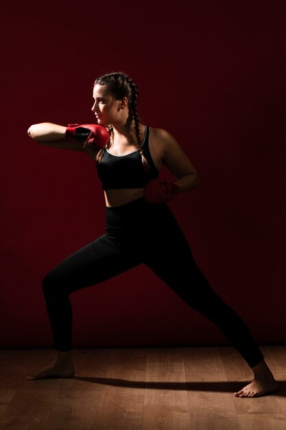 Long view sideways of athletic woman in fitness clothes