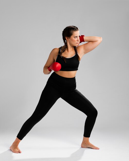 Long view of woman looking away and wearing box gloves