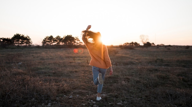 Long view of woman standing in a field