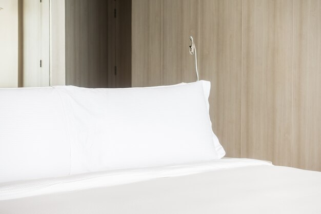 Long white pillow in a bed