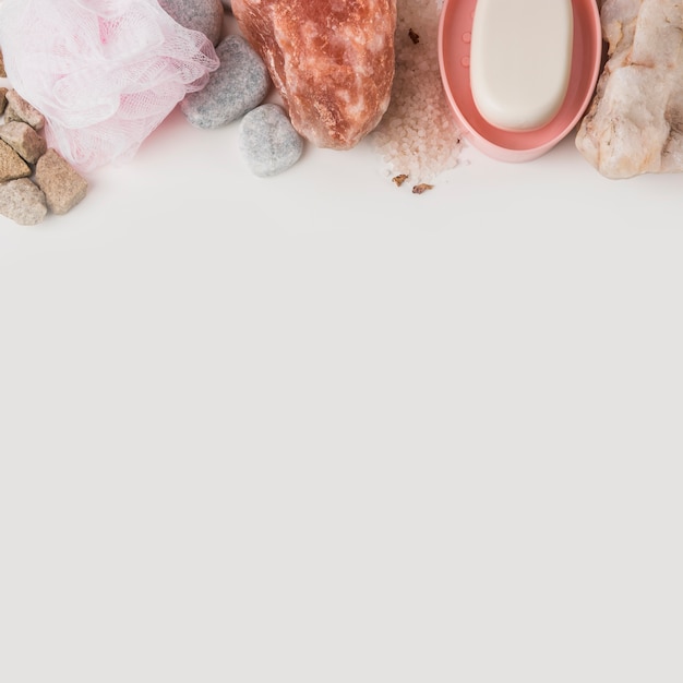 Loofah; spa stone; himalayan pink rock salt and soap on white background