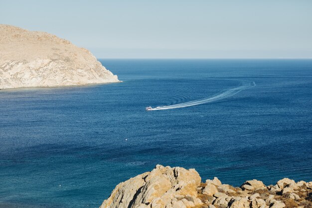 Look from afar at the boat crossing the sea somewhere in Greece