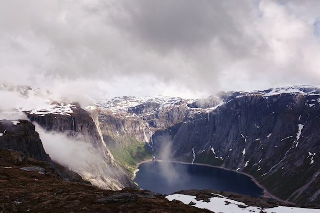 노르웨이에서 키 큰 바위 가운데 푸른 호수 위에서 볼