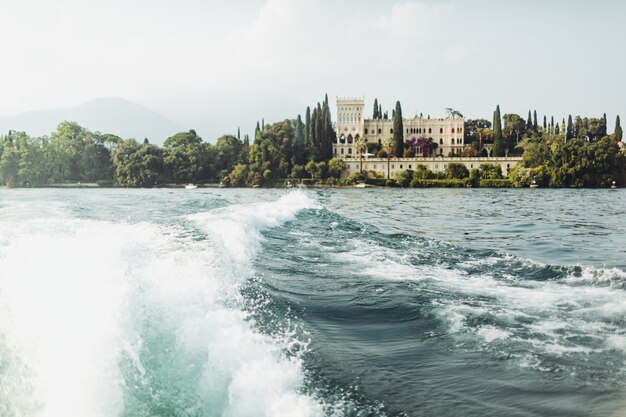 Look from a boat at beautiful estate on the shore. Italy