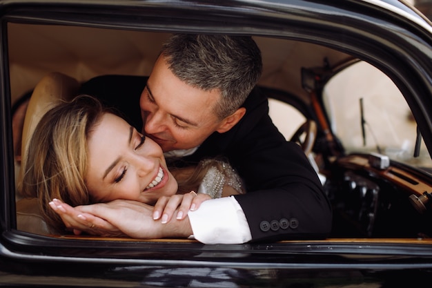 Free photo look from the outside at adorable wedding couple in classy dress