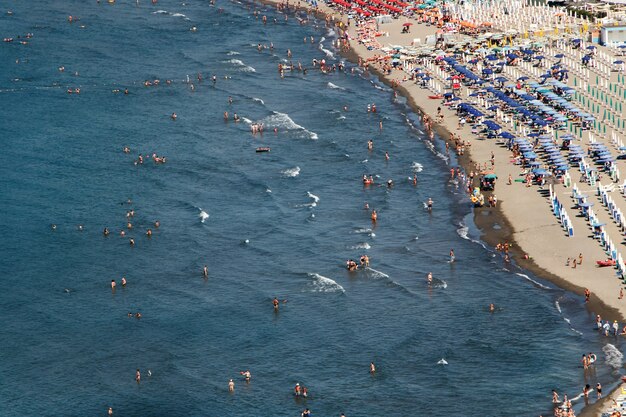 Look from above at people resting on a golden beach