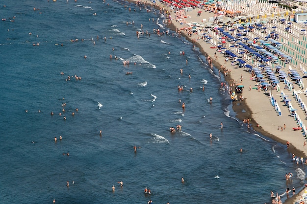Look from above at people resting on a golden beach