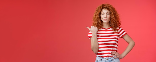 Free photo look that stuff redhead curious sassy goodlooking curlyhaired girl summer striped tshirt smirking ga